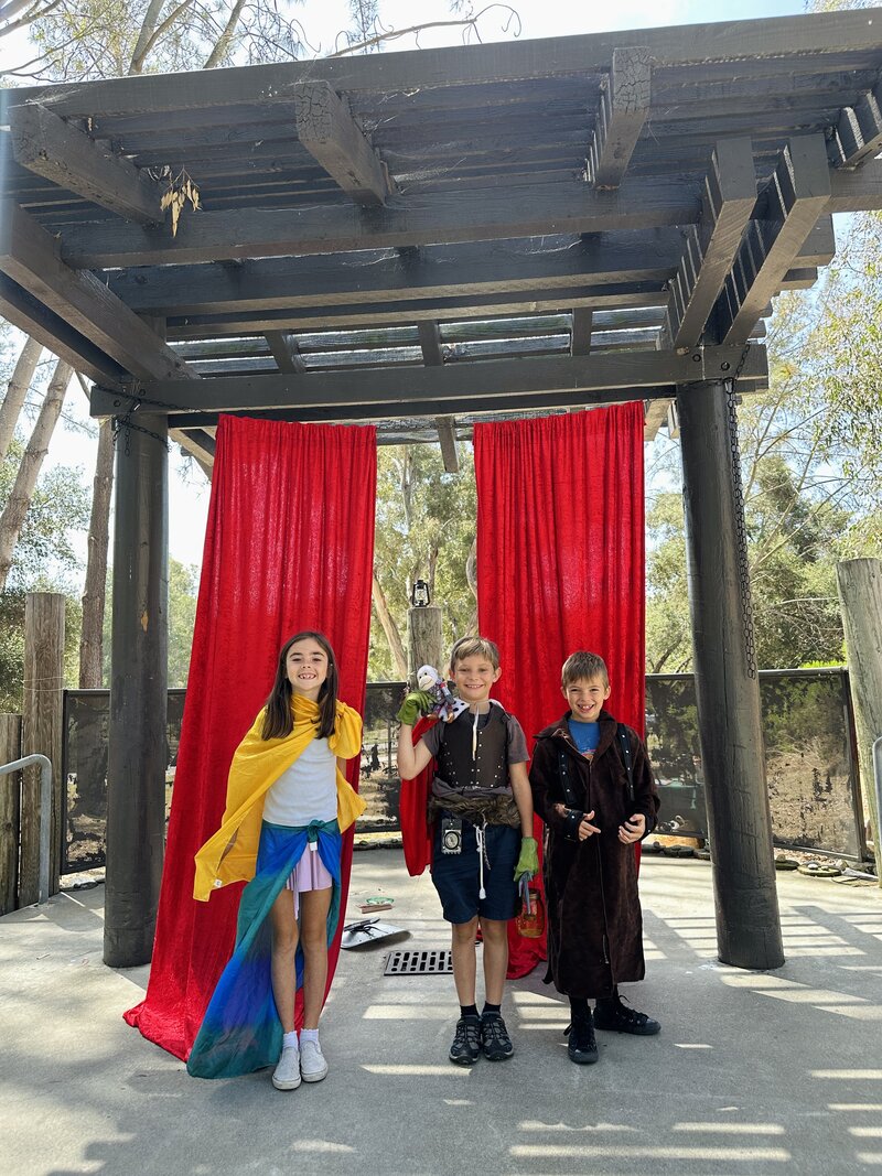 Three children performing on the outdoor stage